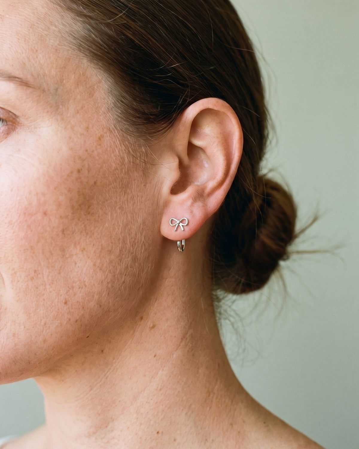 Bow Open Hoop in Sterling Silver, worn on the ear