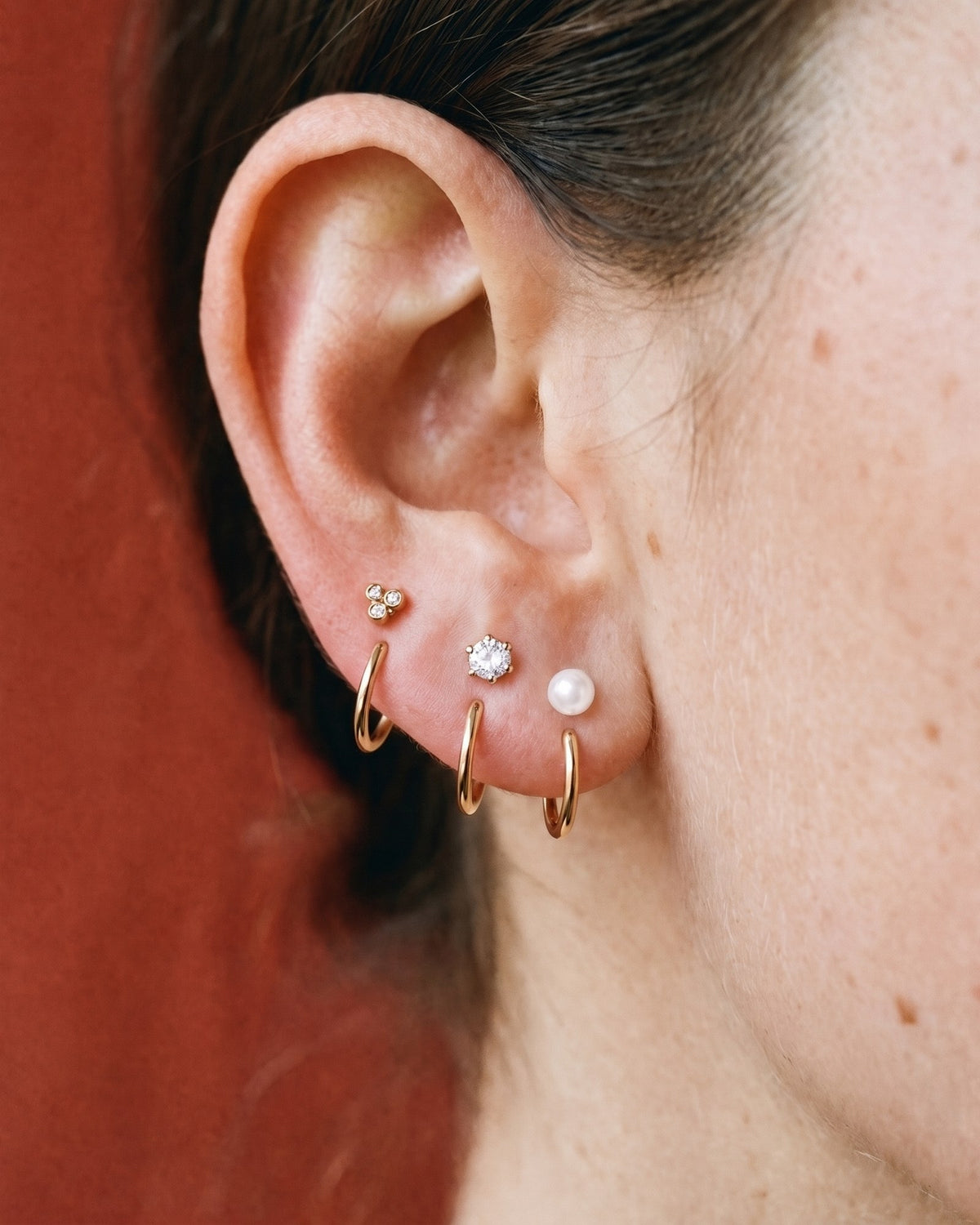 The Clear Cluster, Round and White Bead set in 18K Rose Gold Vermeil, worn on one ear