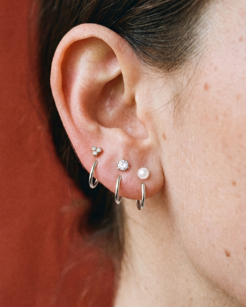 The Clear Cluster, Round and White Bead set in Sterling Silver, worn on one ear