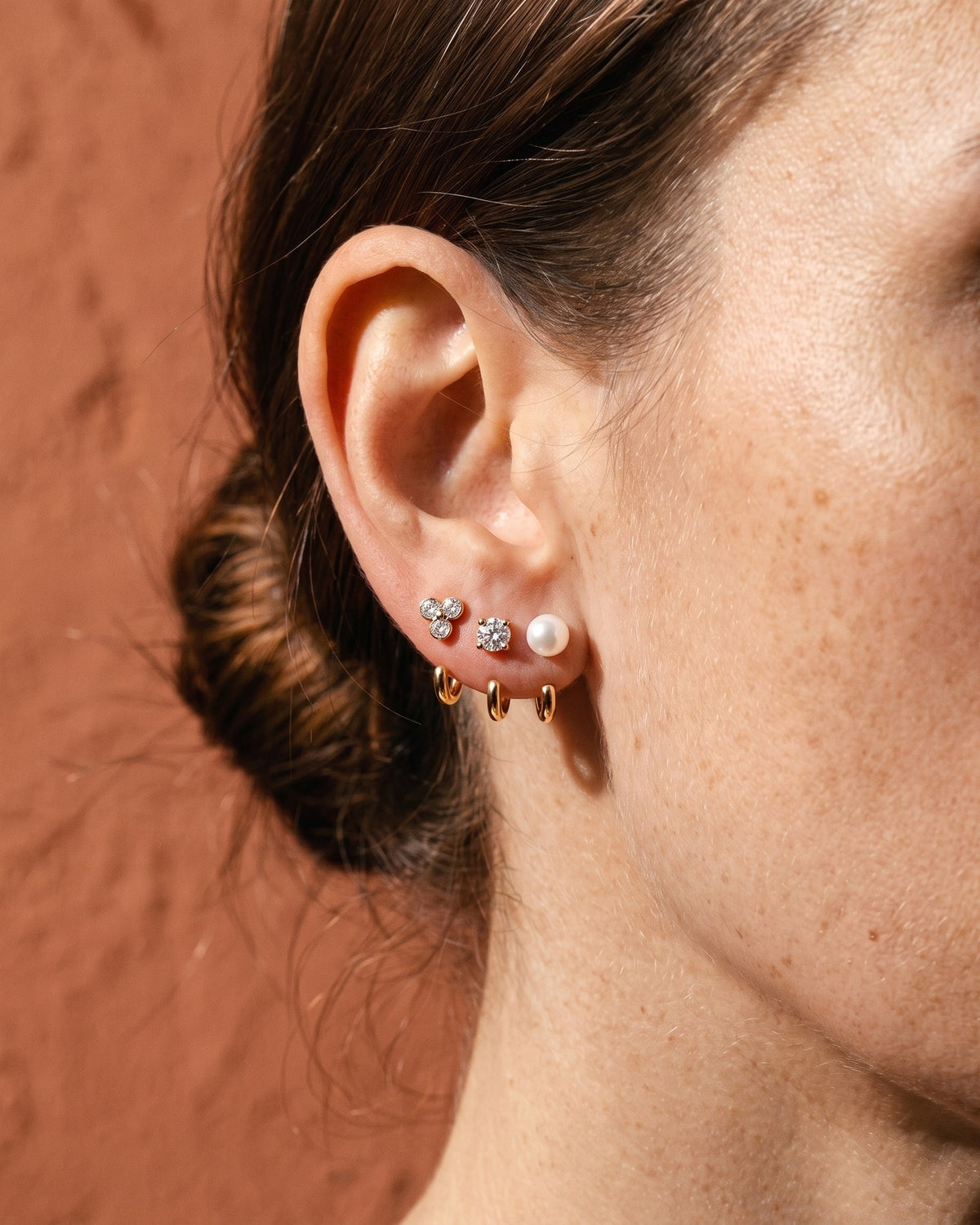 The Clear Cluster, Round and White Bead set in 18K Gold Vermeil, worn on one ear