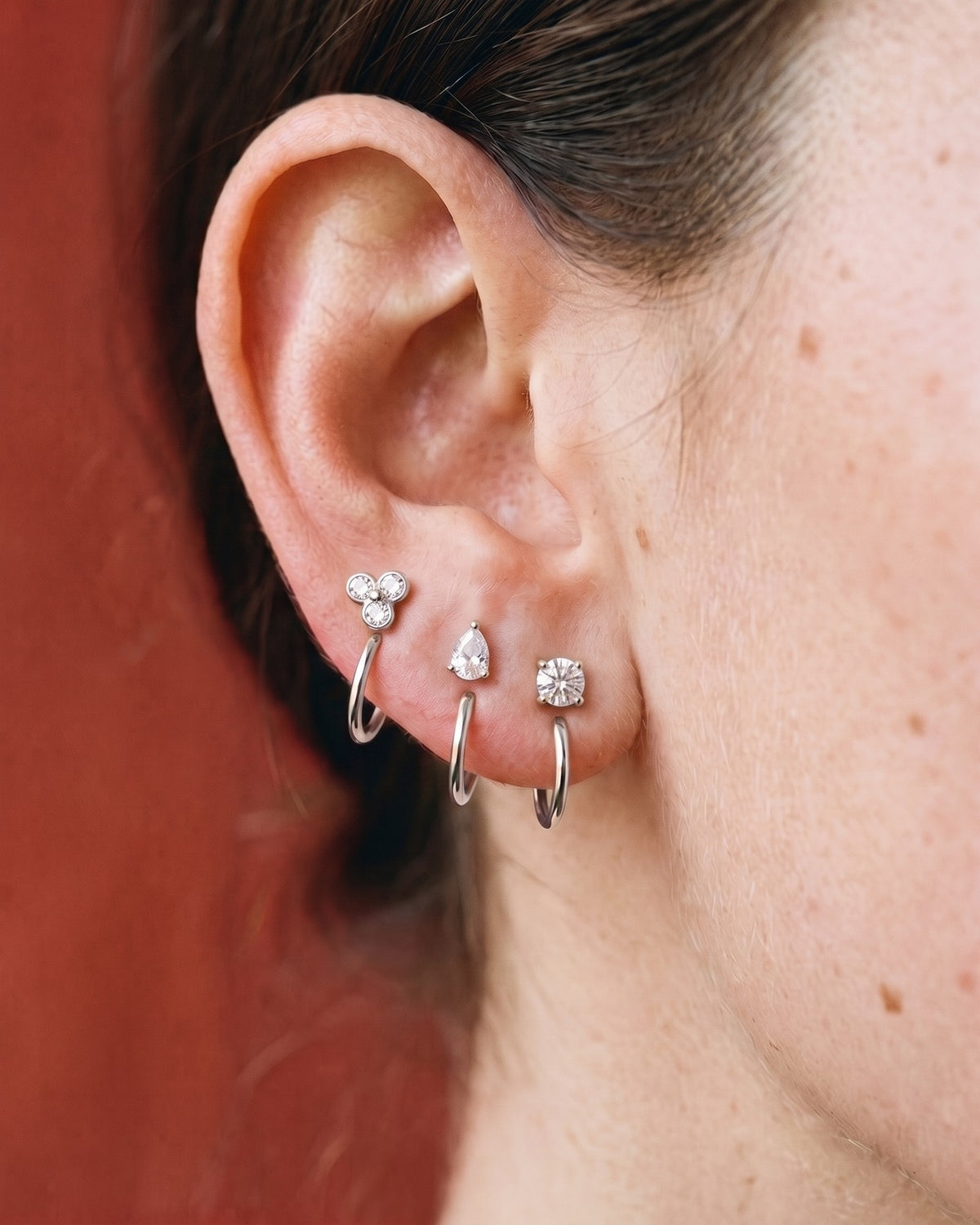 The Clear Cluster, Teardrop and Round set in Sterling Silver, worn on one ear