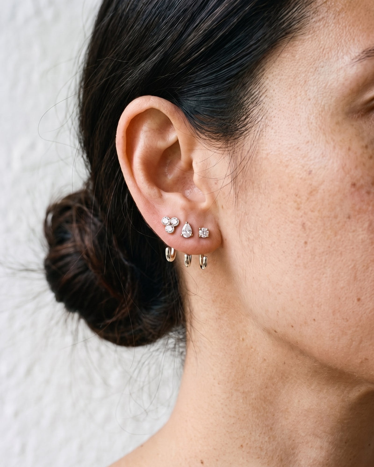 The Clear Cluster, Teardrop and Round set in Sterling Silver, worn on one ear