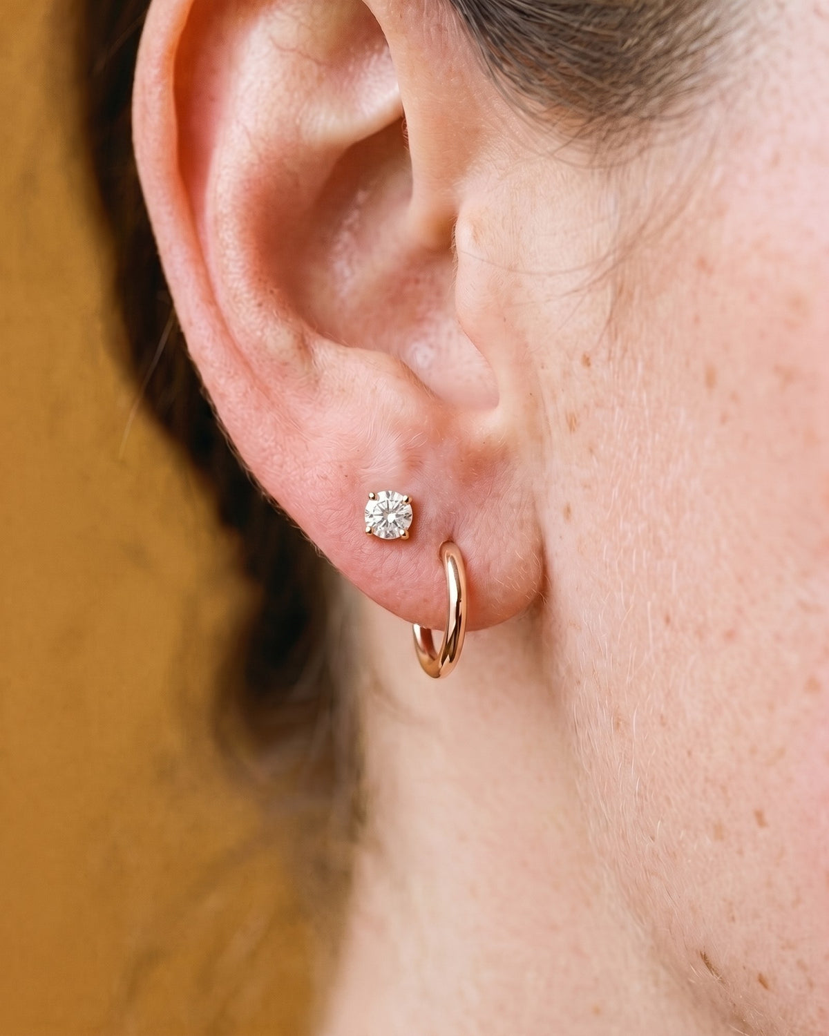 Clear Round Open Hoop in 18K Rose Gold Vermeil, worn on the ear