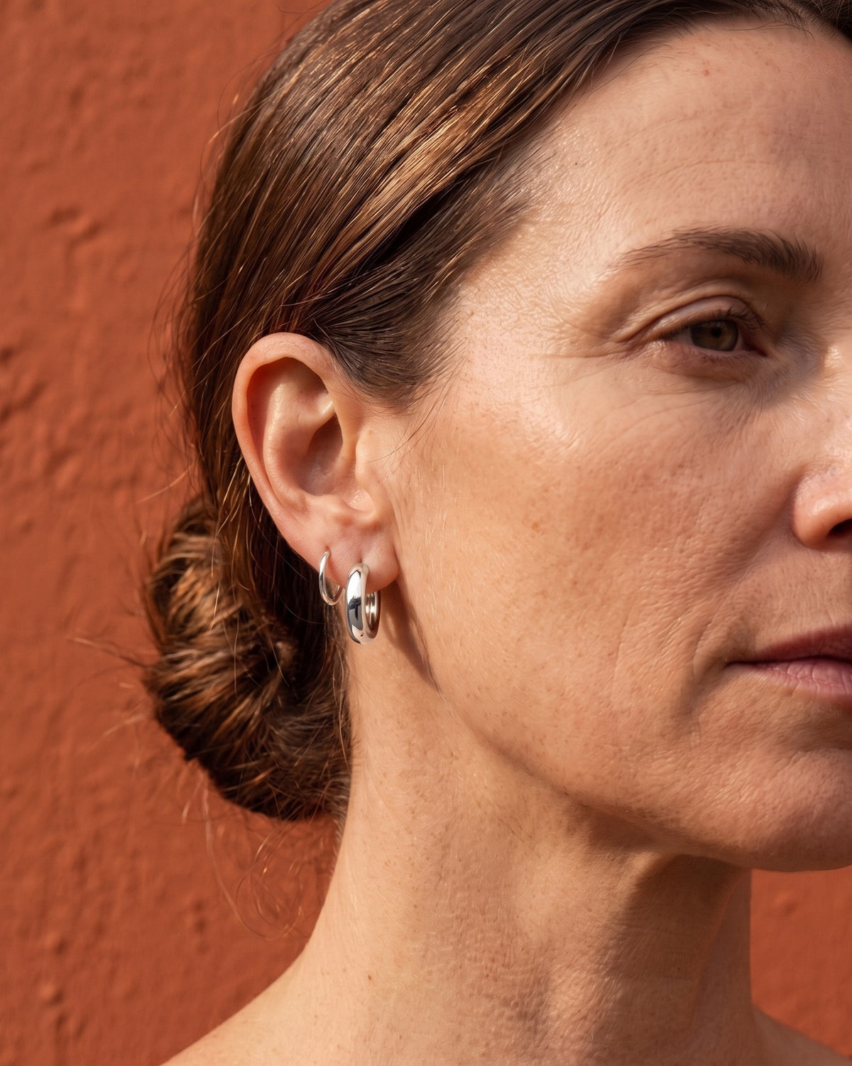 Plain Huggie in Sterling Silver, worn on the ear