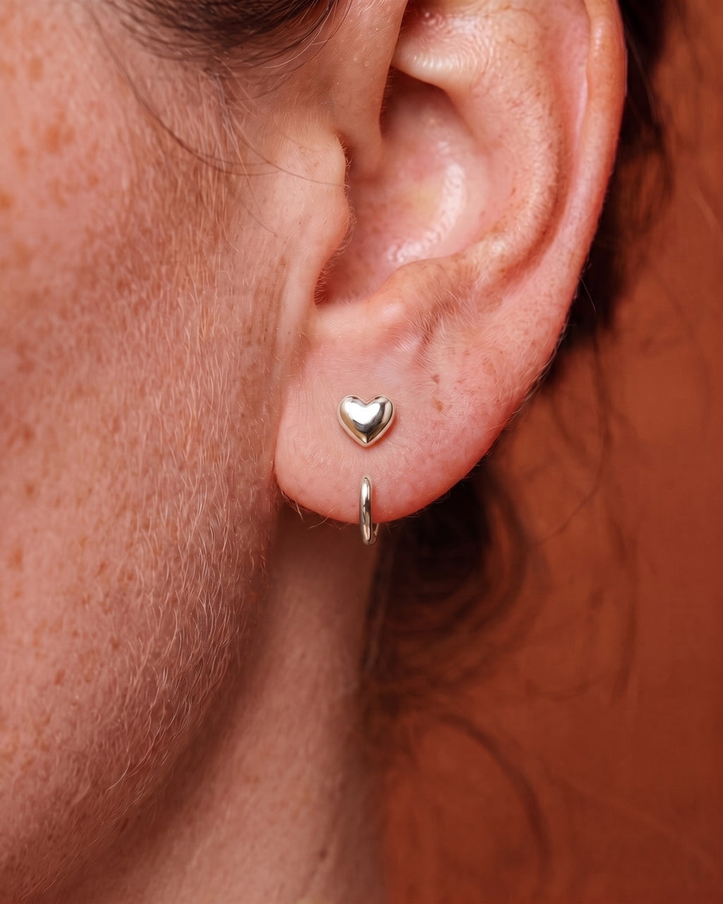 Puffy Heart Open Hoop in Sterling Silver, worn on the ear