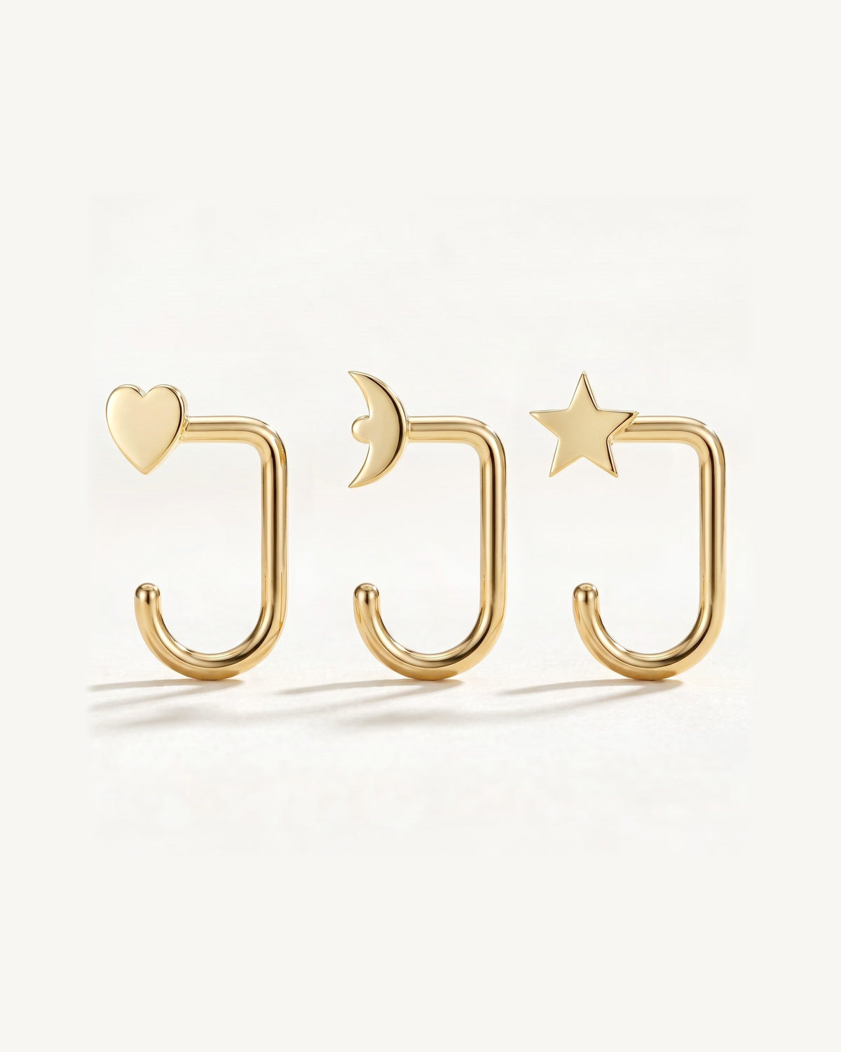 Star, Crescent and Heart, 18K Gold Vermeil, the three pieces side by side