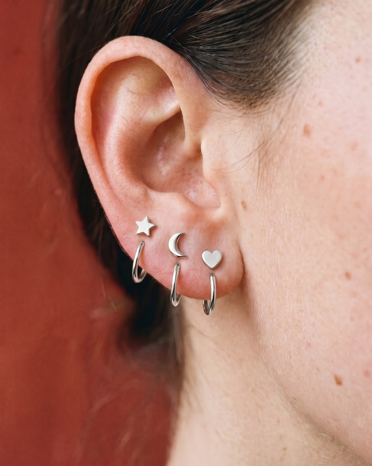 The Star, Crescent and Heart set in Sterling Silver, worn on one ear