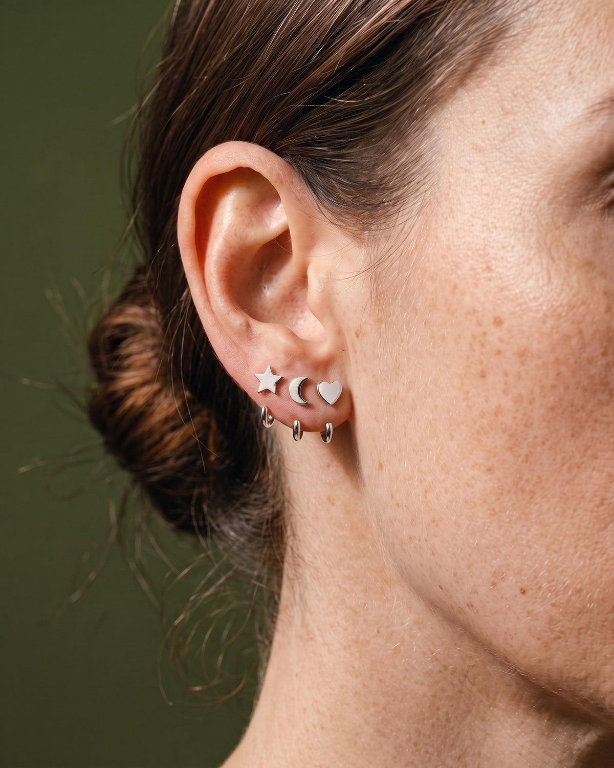 The Star, Crescent and Heart set in Sterling Silver, worn on one ear