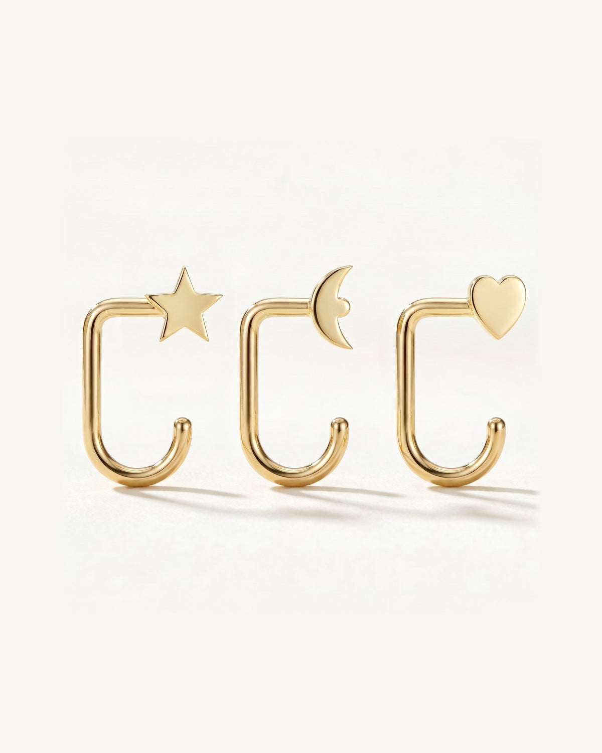 Star, Crescent and Heart, 18K Gold Vermeil, the three pieces side by side
